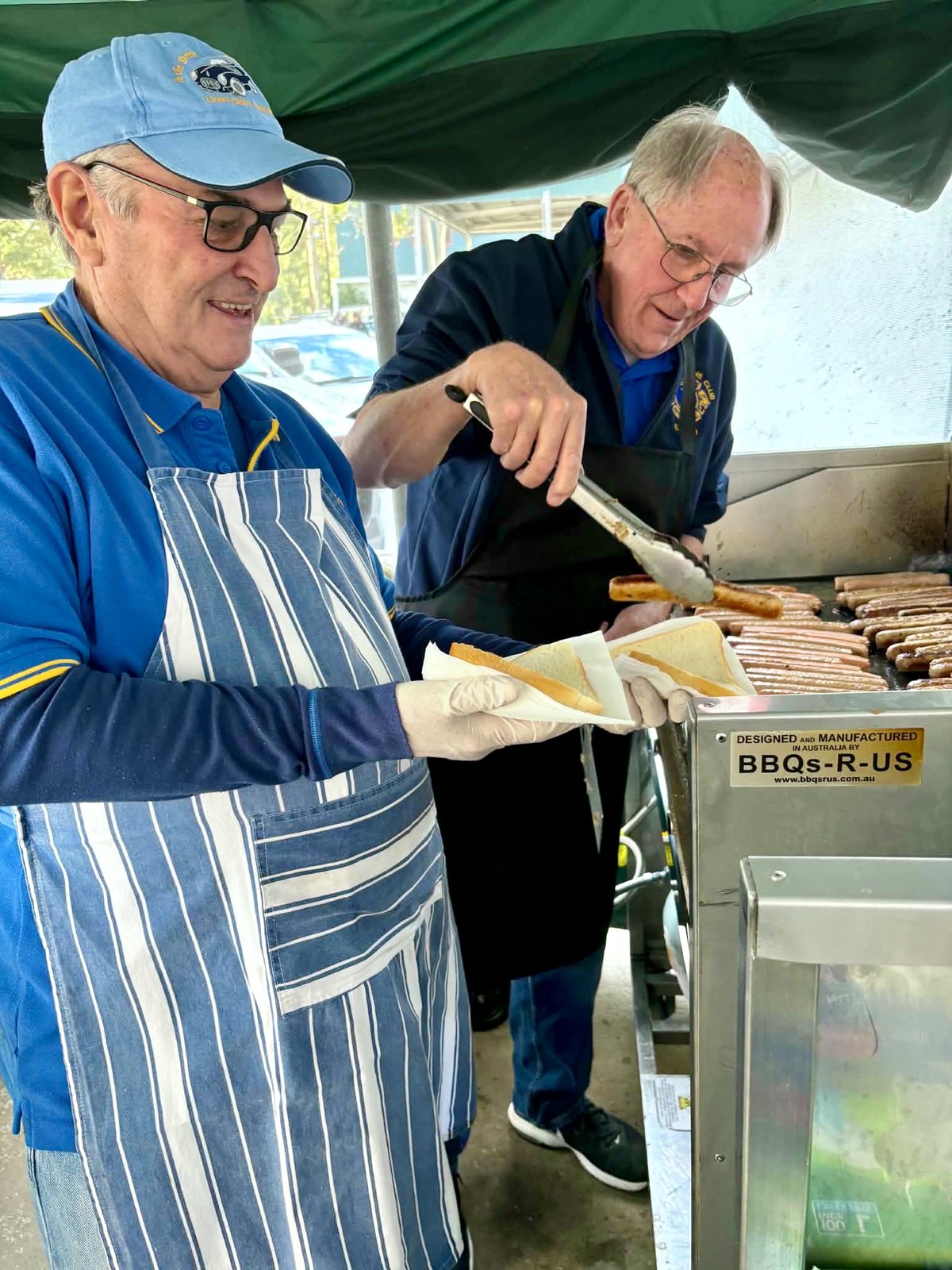 Nillumbik Lions members serving at a community barbecue