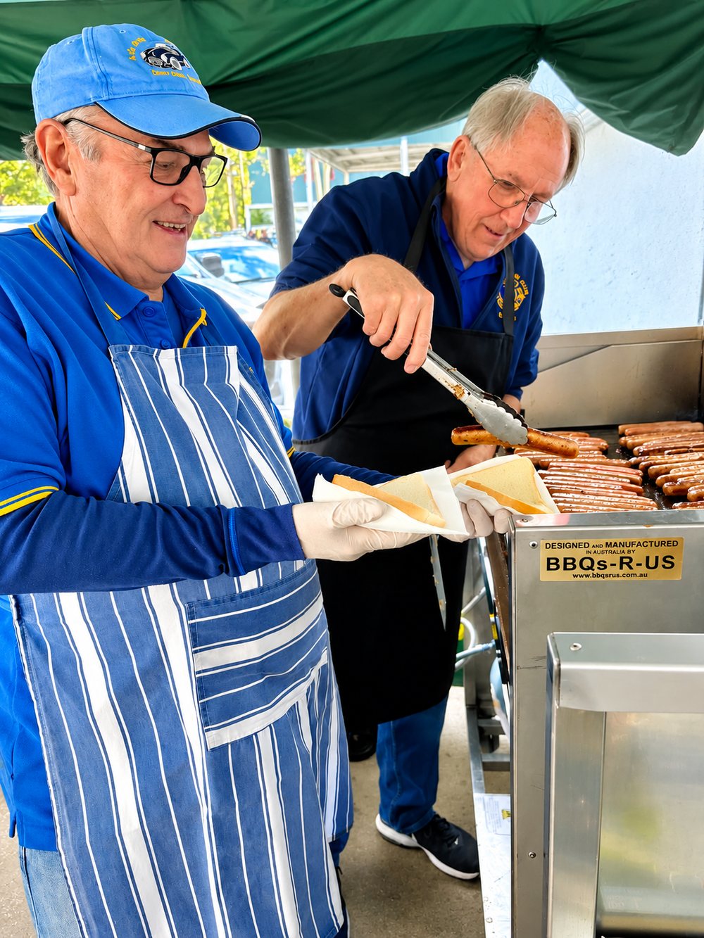 Nillumbik Lions members serving at a community barbecue